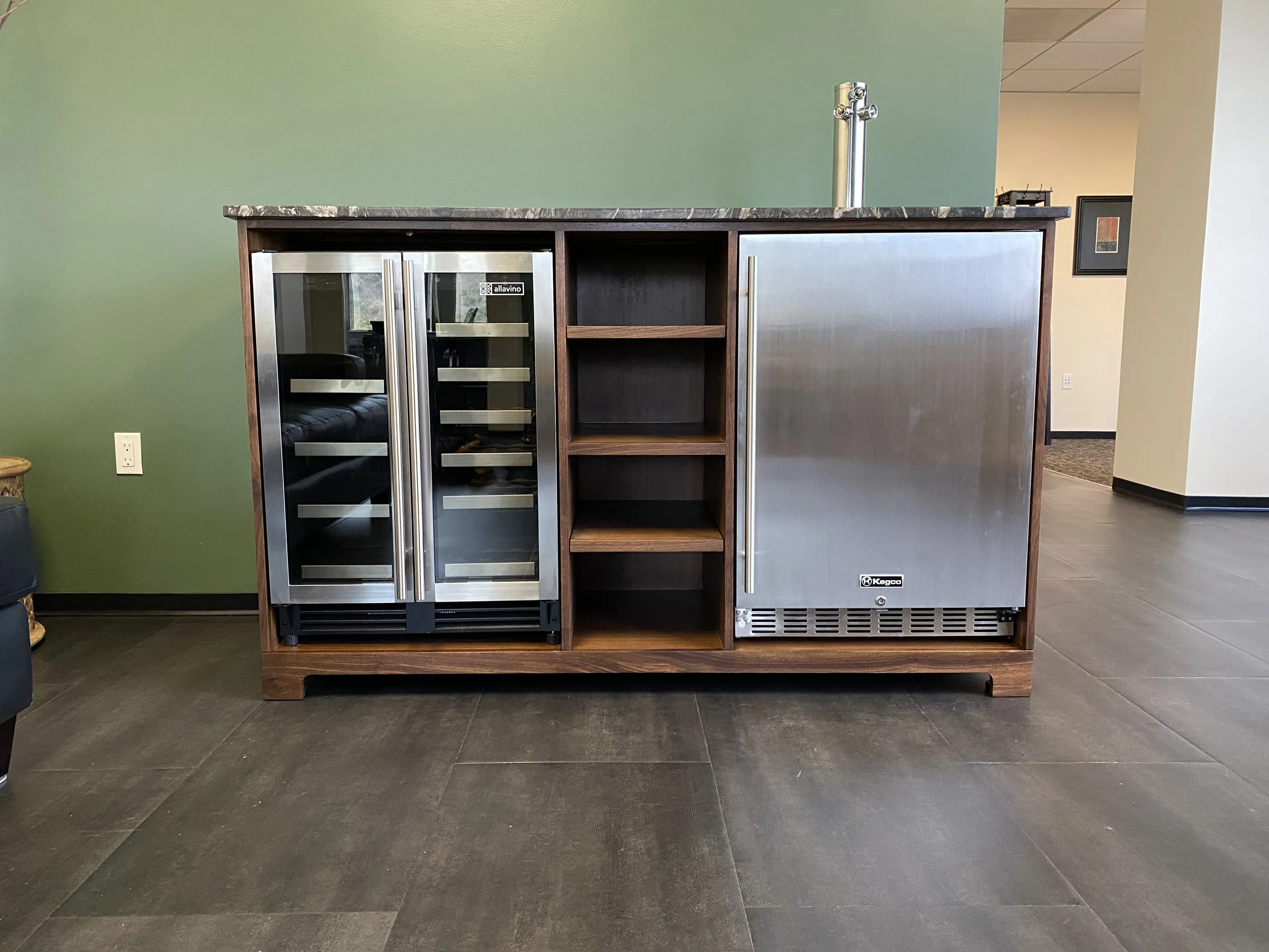 The walnut bar cabinet straight on, showing the wine refrigerator, the four open shelves and the kegerator beneath the stone top.